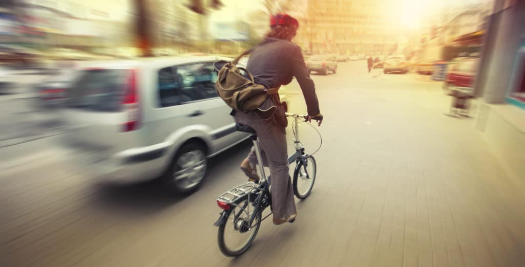 cyclist in traffic on the city roadway motion blur