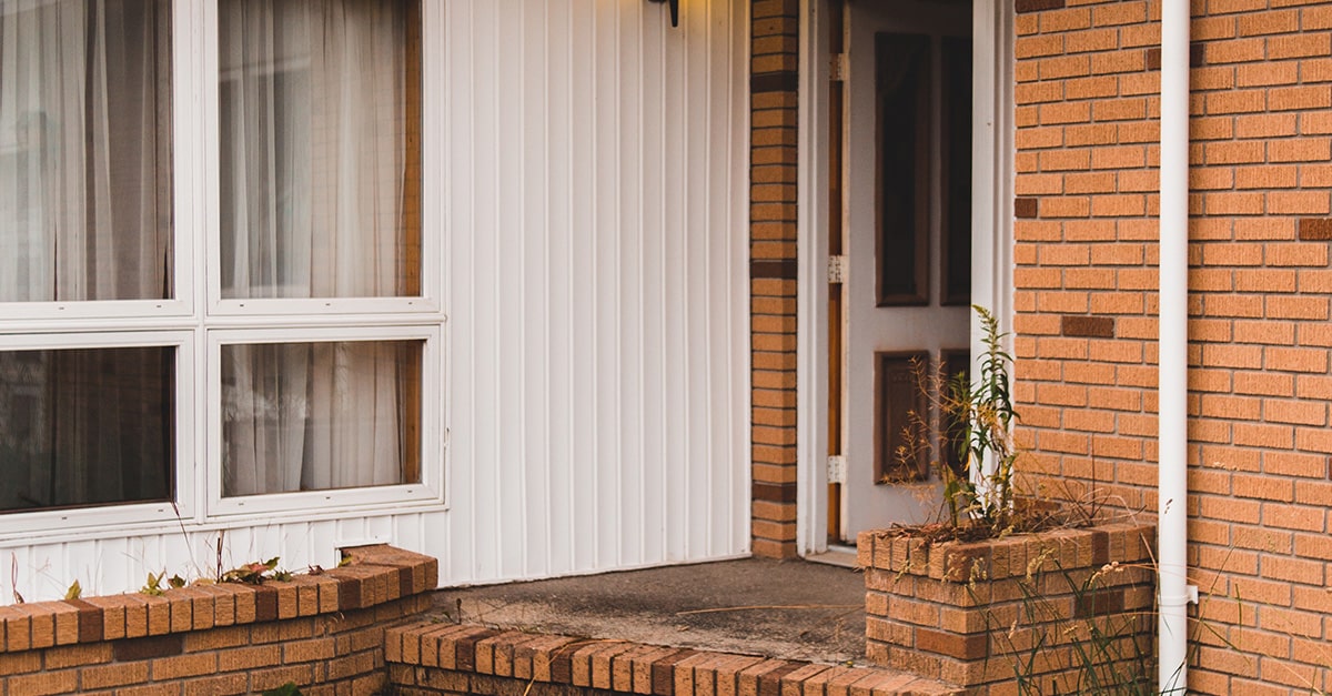 Image of an open front door. This image is used to illustrate the concept of police search of homes for safety purposes of individual(s) inside the home.