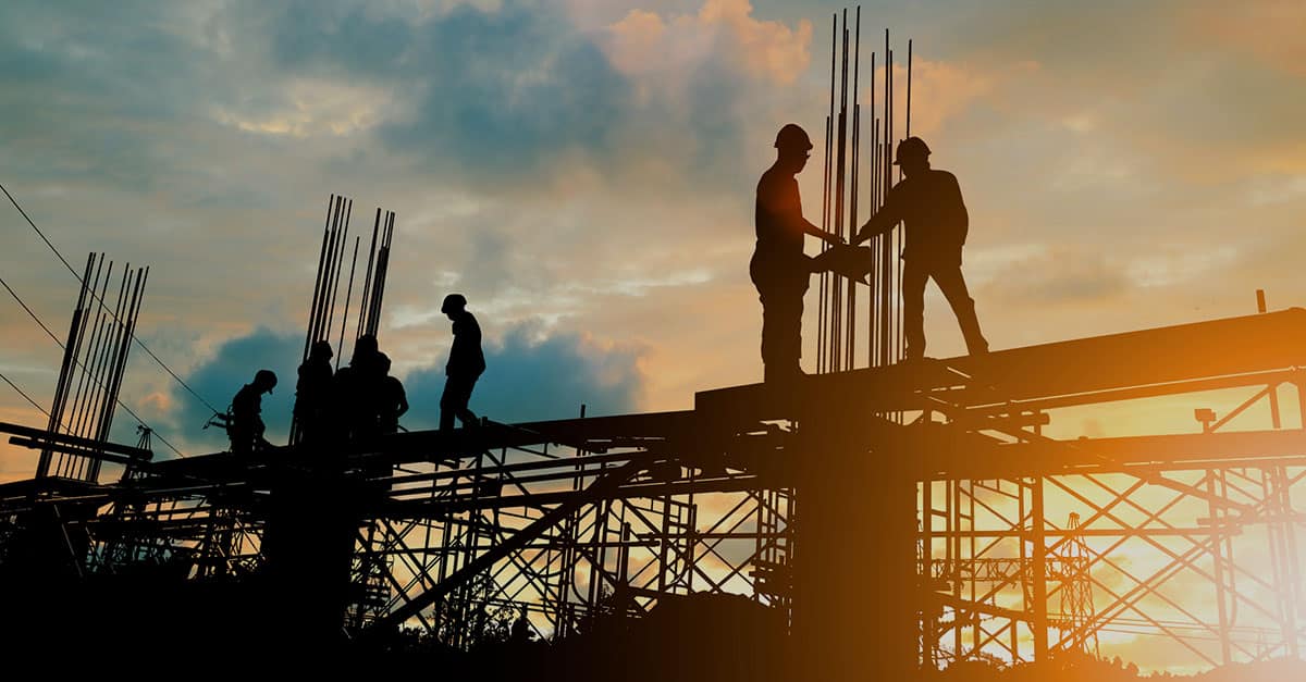 Silhouette of engineer and workers on a construction site. The image is used to communicate that the prompt payment legislation applies to the construction industry.